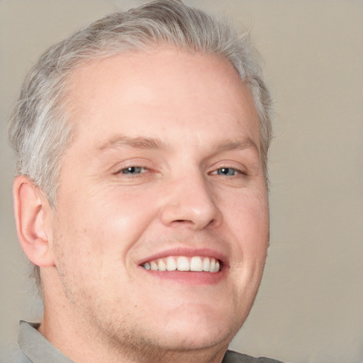 Joyful white adult male with short  brown hair and grey eyes