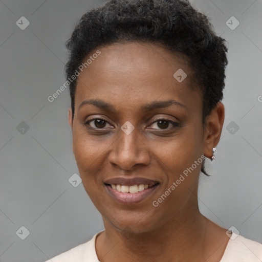 Joyful black young-adult female with short  black hair and brown eyes