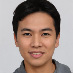 Joyful asian young-adult male with short  black hair and brown eyes