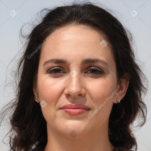 Joyful white adult female with long  brown hair and brown eyes