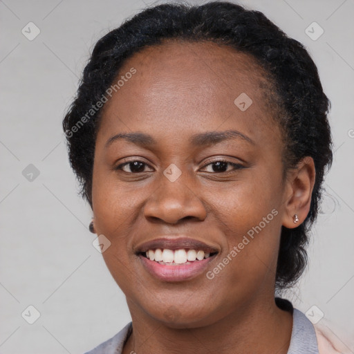 Joyful black young-adult female with short  black hair and brown eyes