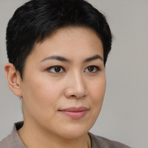 Joyful asian young-adult female with short  brown hair and brown eyes