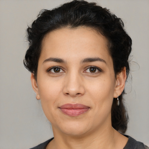 Joyful latino young-adult female with medium  black hair and brown eyes