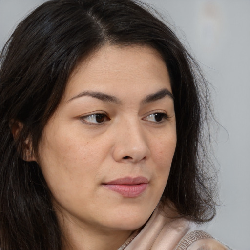 Joyful asian young-adult female with long  brown hair and brown eyes