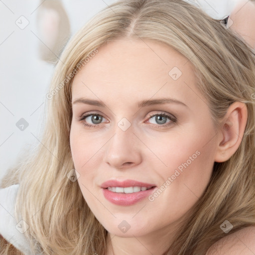 Joyful white young-adult female with long  brown hair and blue eyes