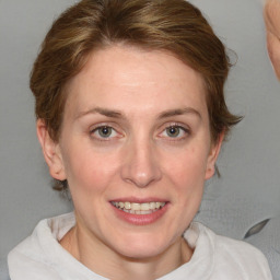 Joyful white young-adult female with medium  brown hair and blue eyes