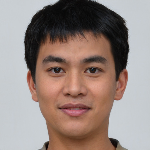 Joyful asian young-adult male with short  brown hair and brown eyes