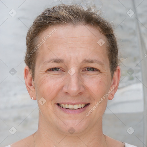 Joyful white adult female with short  brown hair and grey eyes