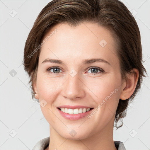 Joyful white young-adult female with medium  brown hair and grey eyes