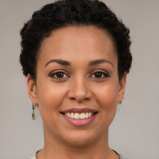 Joyful latino young-adult female with short  brown hair and brown eyes