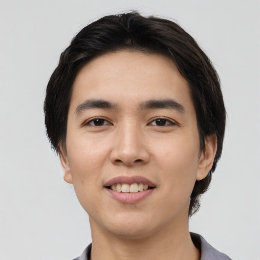 Joyful white young-adult male with short  black hair and brown eyes