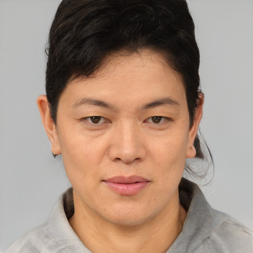 Joyful asian adult female with short  brown hair and brown eyes