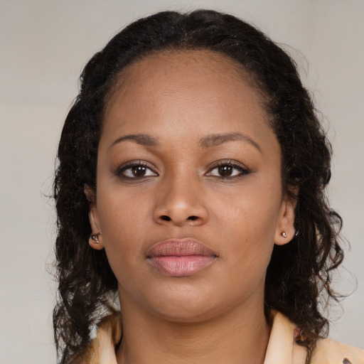Neutral black young-adult female with medium  brown hair and brown eyes