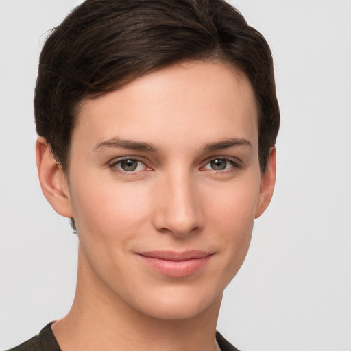 Joyful white young-adult female with short  brown hair and grey eyes