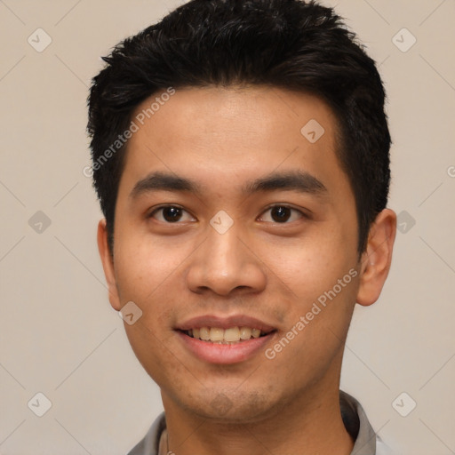 Joyful asian young-adult male with short  black hair and brown eyes