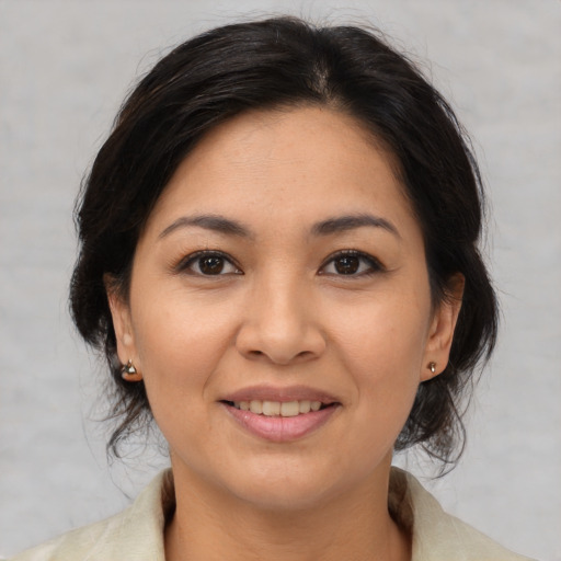 Joyful asian young-adult female with medium  brown hair and brown eyes