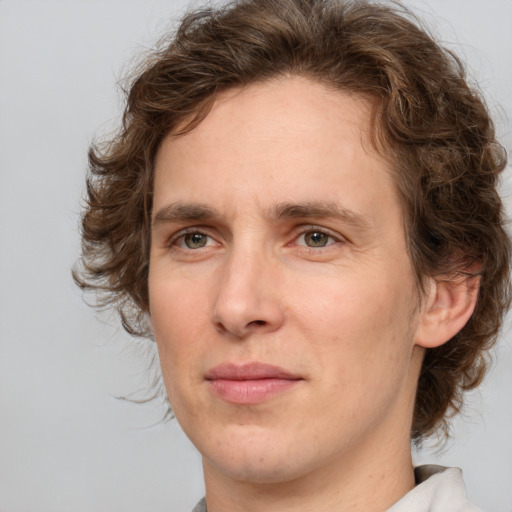 Joyful white young-adult male with medium  brown hair and brown eyes