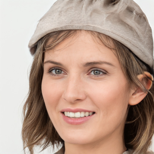 Joyful white young-adult female with medium  brown hair and grey eyes