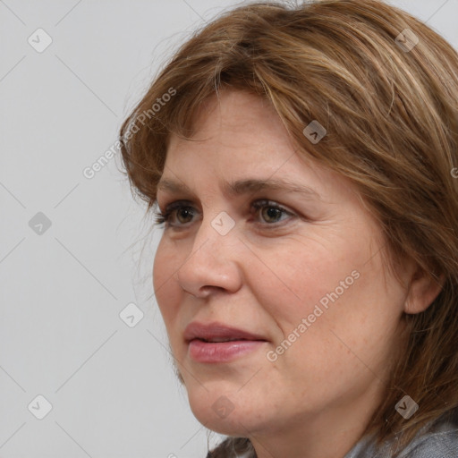 Joyful white adult female with medium  brown hair and grey eyes