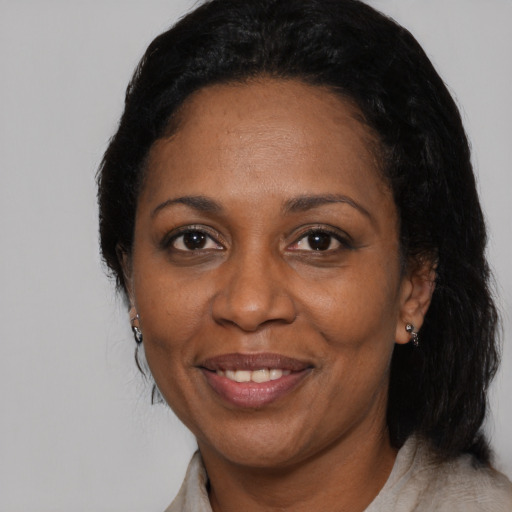 Joyful black adult female with medium  black hair and brown eyes