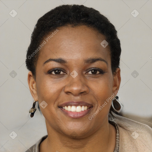 Joyful black young-adult female with short  black hair and brown eyes