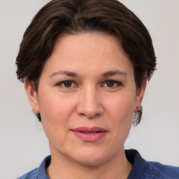 Joyful white adult female with medium  brown hair and brown eyes