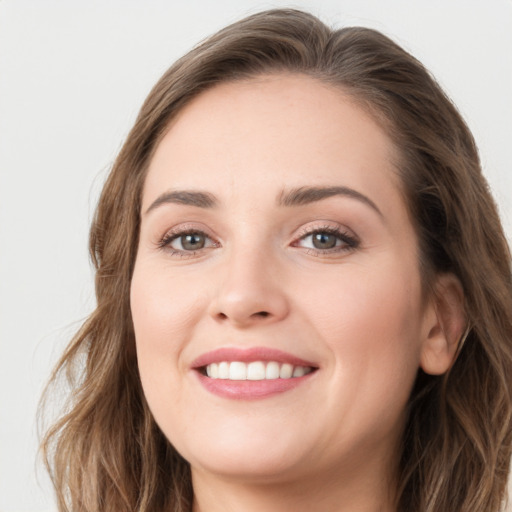 Joyful white young-adult female with long  brown hair and green eyes