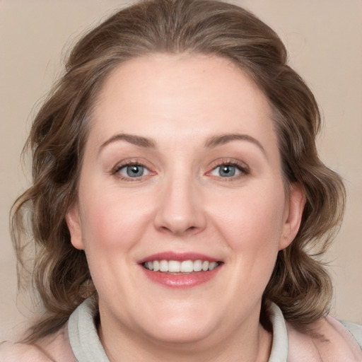 Joyful white young-adult female with medium  brown hair and blue eyes