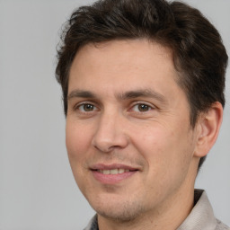 Joyful white adult male with short  brown hair and brown eyes