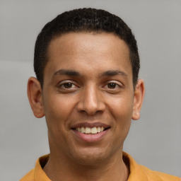 Joyful latino young-adult male with short  brown hair and brown eyes