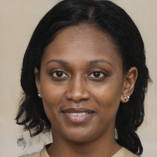Joyful black young-adult female with medium  black hair and brown eyes
