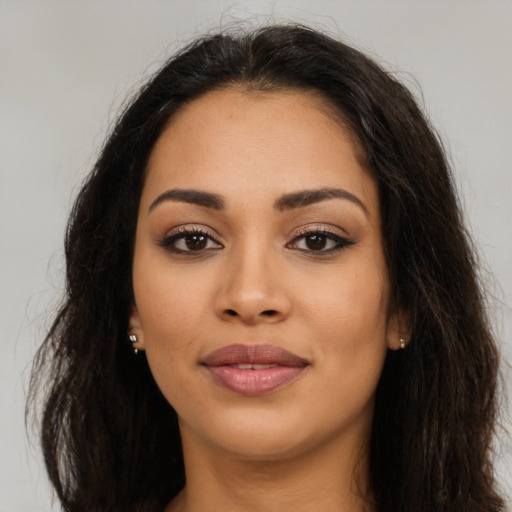 Joyful latino young-adult female with long  brown hair and brown eyes