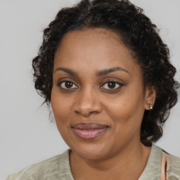 Joyful black young-adult female with medium  brown hair and brown eyes