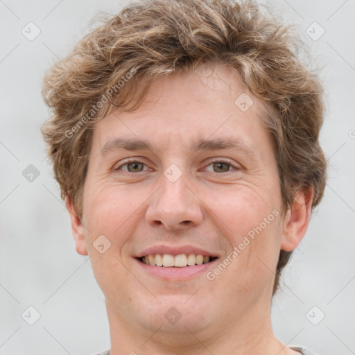 Joyful white adult male with short  brown hair and grey eyes