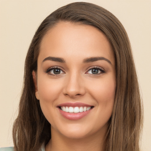 Joyful white young-adult female with long  brown hair and brown eyes