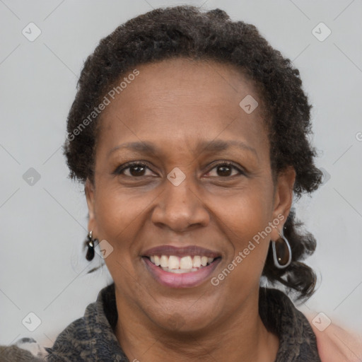 Joyful black adult female with short  brown hair and brown eyes