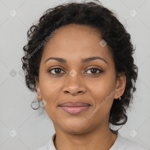 Joyful black adult female with short  brown hair and brown eyes