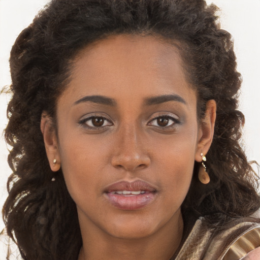 Joyful black young-adult female with long  brown hair and brown eyes