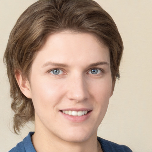 Joyful white young-adult female with medium  brown hair and blue eyes