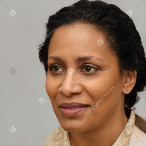 Joyful black adult female with short  brown hair and brown eyes