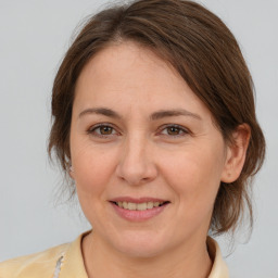 Joyful white adult female with medium  brown hair and brown eyes