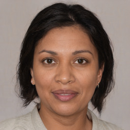 Joyful black adult female with medium  brown hair and brown eyes