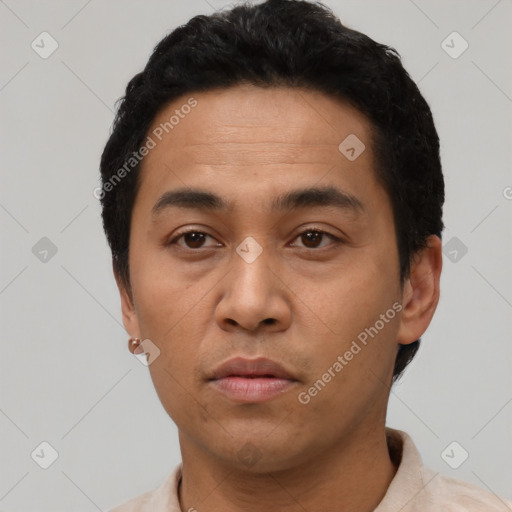 Neutral latino young-adult male with short  black hair and brown eyes