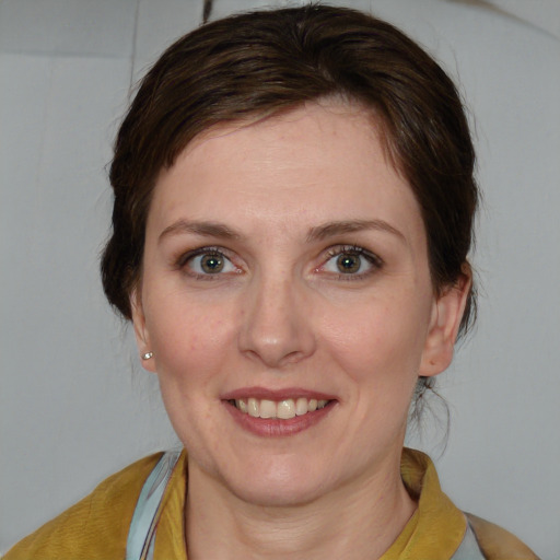 Joyful white young-adult female with medium  brown hair and blue eyes