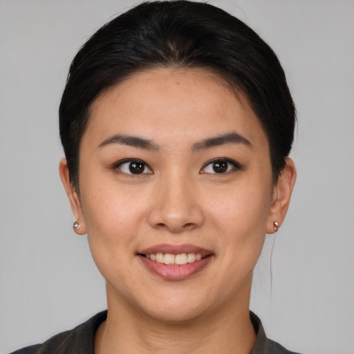 Joyful asian young-adult female with short  brown hair and brown eyes