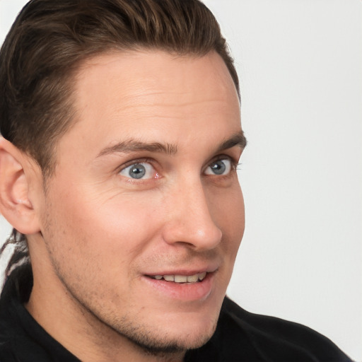 Joyful white young-adult male with short  brown hair and grey eyes