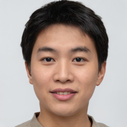 Joyful asian young-adult male with short  black hair and brown eyes