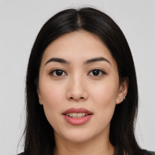 Joyful white young-adult female with long  black hair and brown eyes