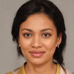 Joyful latino young-adult female with medium  brown hair and brown eyes