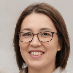 Joyful white adult female with medium  brown hair and brown eyes